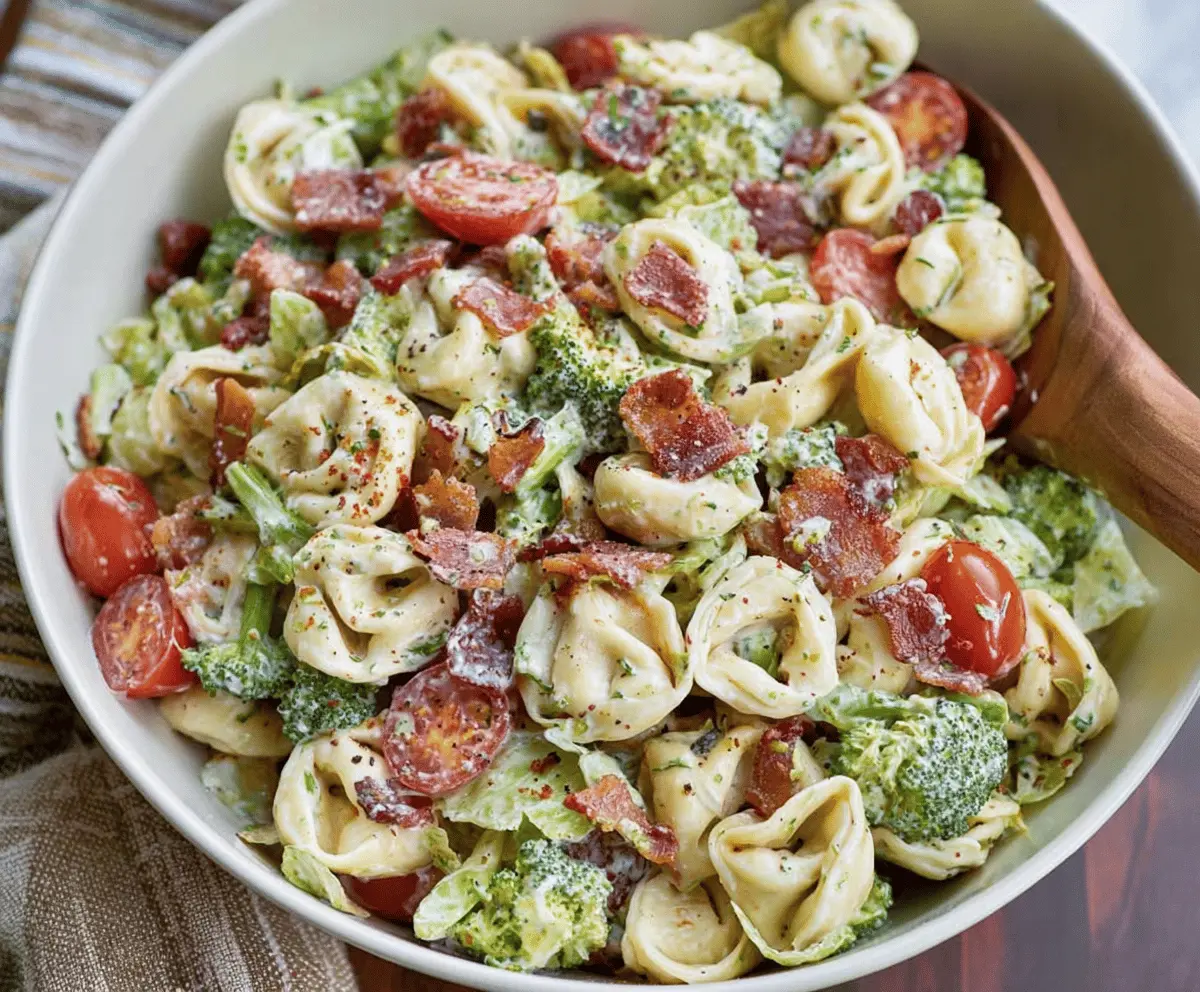 Colorful Broccoli BLT Tortellini Salad with crispy bacon, fresh broccoli florets, cherry tomatoes, and creamy dressing served in a bowl