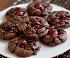 Delicious homemade chocolate cherry cookies with a rich, glossy appearance on a rustic wooden surface.